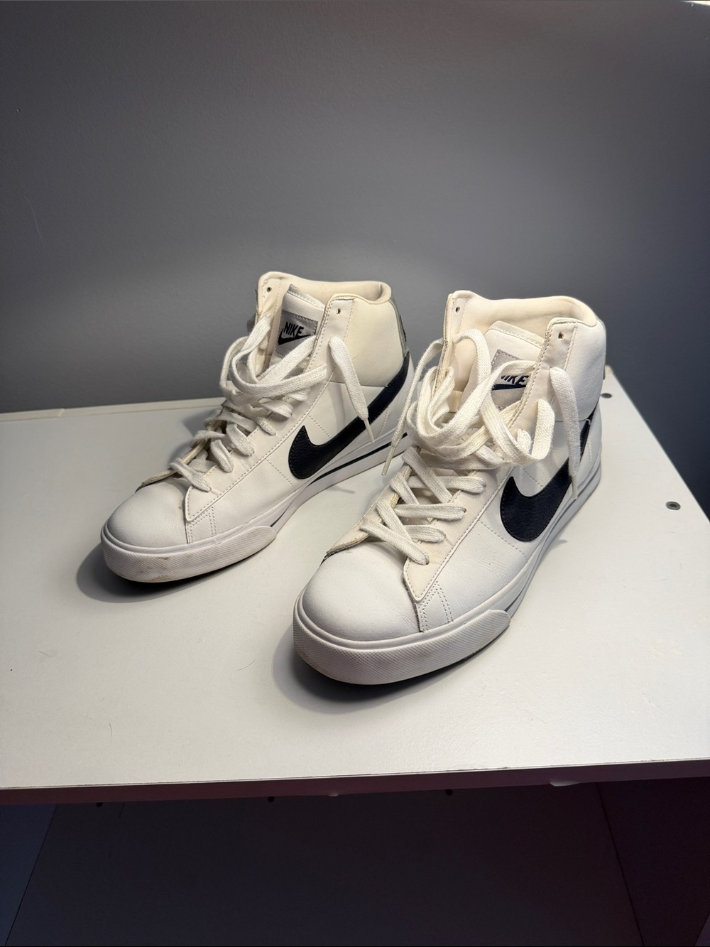 Nike White High-Top Sneakers with Black Swoosh